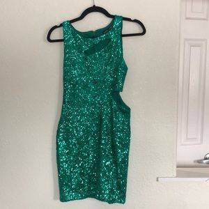 Beautiful green sequin Bebe dress with slits across chest and ribs